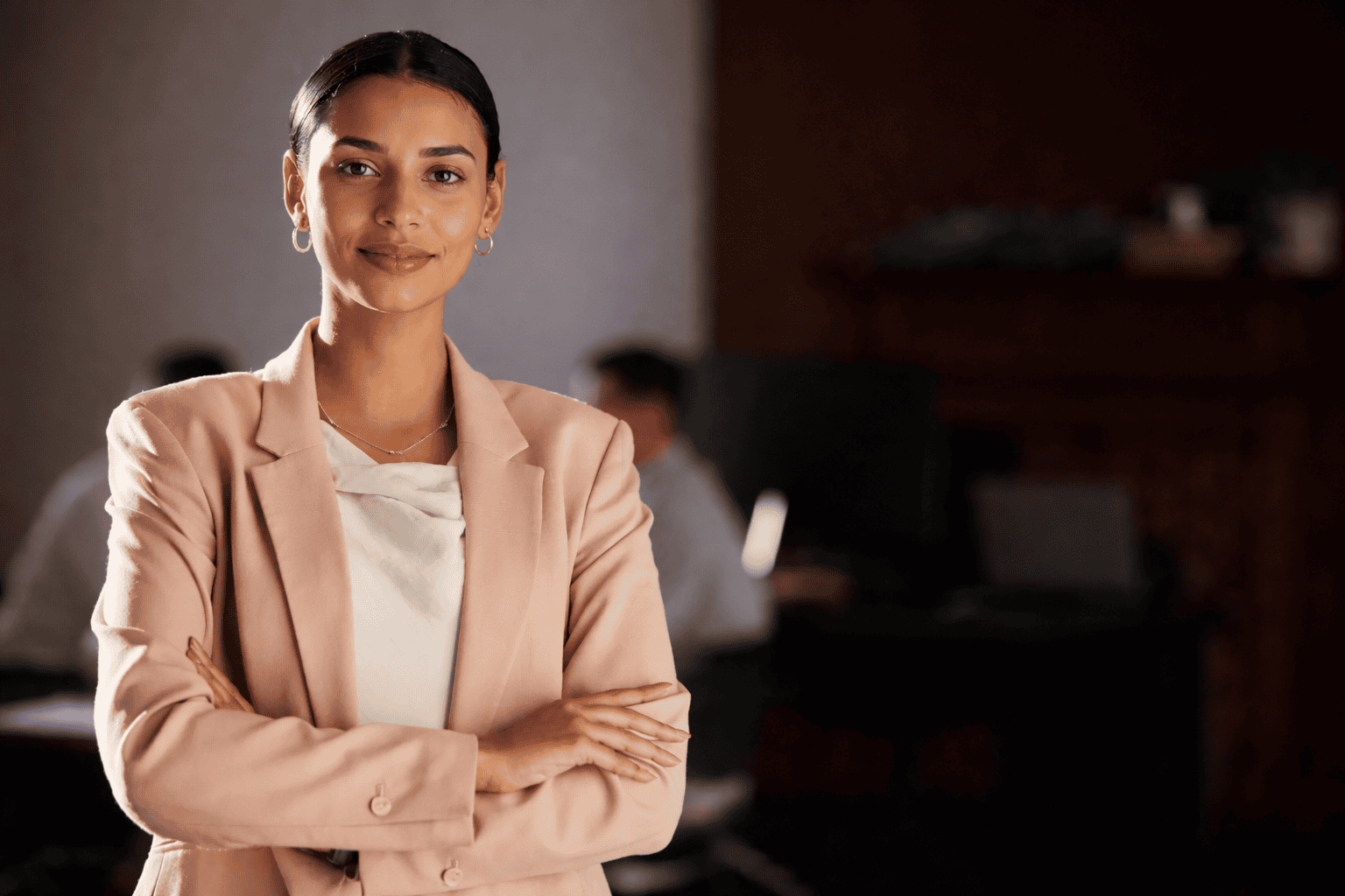 Portrait professionnel de femme en blazer dans un bureau, incarnant confiance, leadership et image d’entreprise